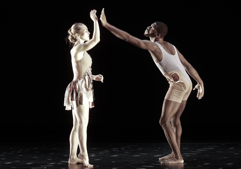 male and female dancer touching hands during performance